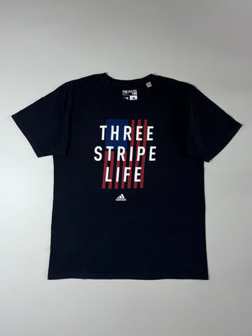 Adidas “Three Stripe Life” USA Flag Graphic Tee – Black (L)