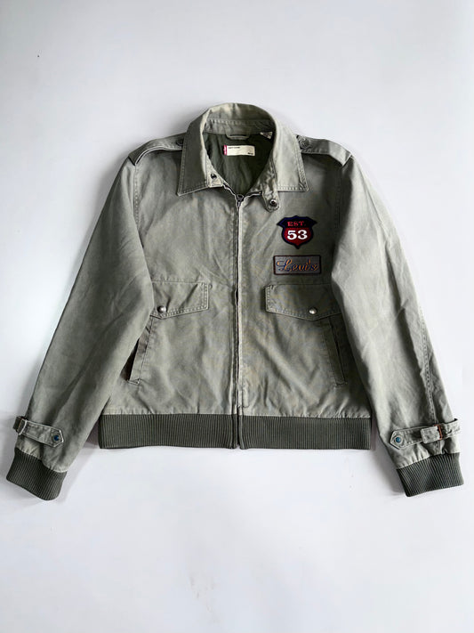 Vintage Levi’s EST. 53 Patch Military Harrington Jacket | Faded Olive Green | Ribbed Hem | Embroidered Patches (L)
